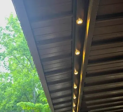 Permanent lighting track hidden in color-matched soffit trim on a Franklin TN home during daytime
