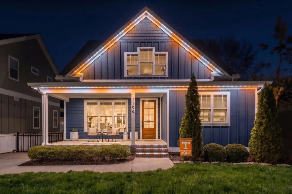Orange and white permanent holiday lighting on a two-story home in Middle Tennessee for game day
