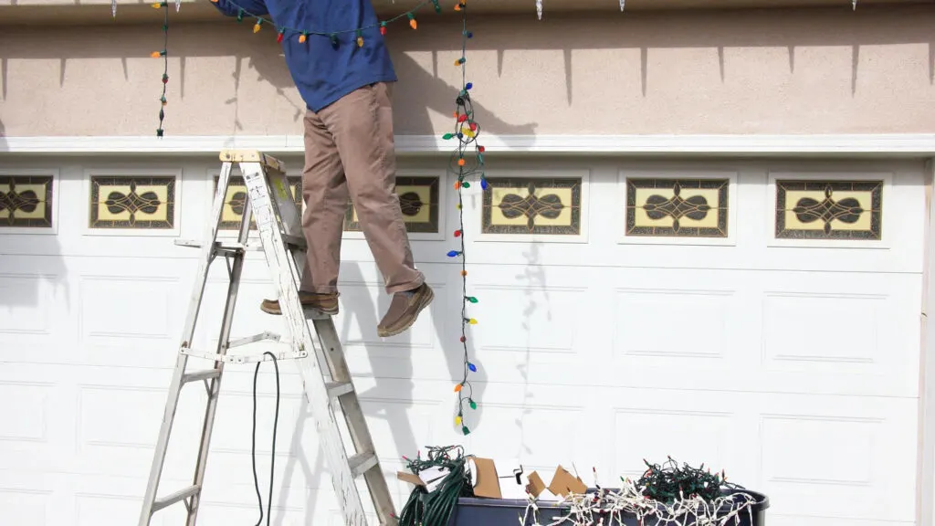 Comparison of dangerous ladder holiday light installation versus maintenance-free permanent roofline lighting in Middle TN